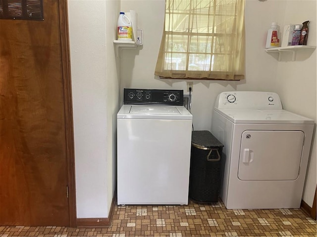 clothes washing area with washing machine and clothes dryer