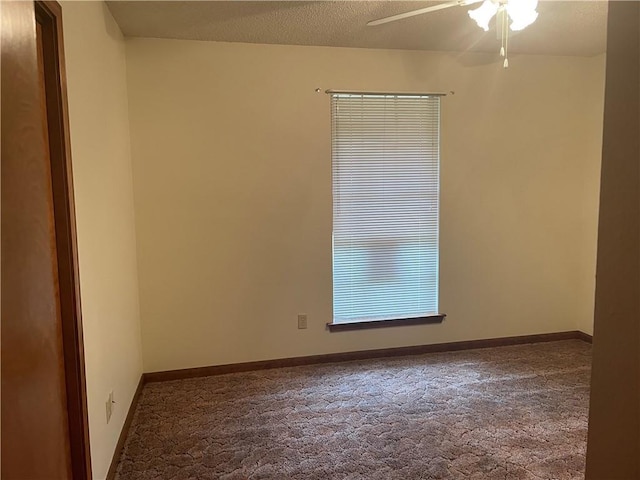 carpeted spare room with a textured ceiling and ceiling fan