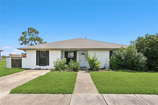 ranch-style home with a front lawn