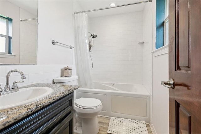 full bathroom with shower / tub combo, vanity, toilet, and hardwood / wood-style floors