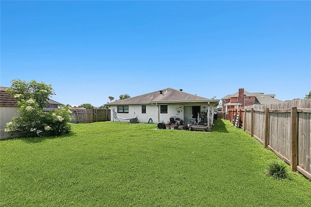 rear view of house with a lawn