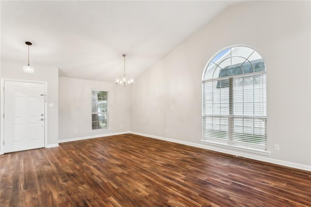 interior space with a notable chandelier, lofted ceiling, and dark wood-type flooring