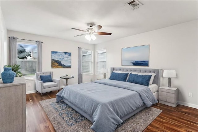 bedroom with dark hardwood / wood-style floors and ceiling fan