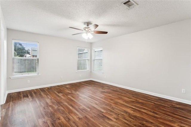 unfurnished room featuring ceiling fan, dark hardwood / wood-style flooring, and a textured ceiling