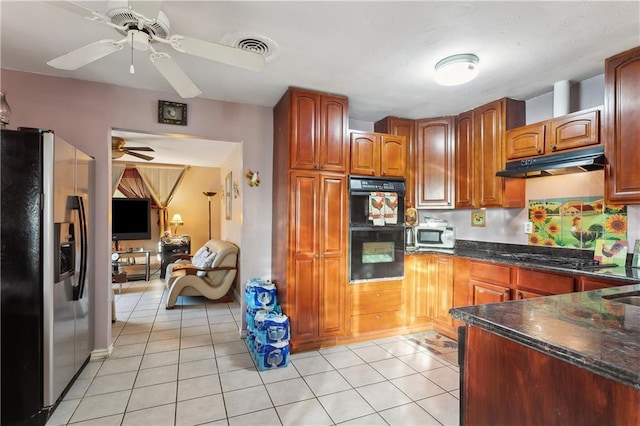 kitchen with black appliances, ceiling fan, light tile patterned floors, and dark stone counters