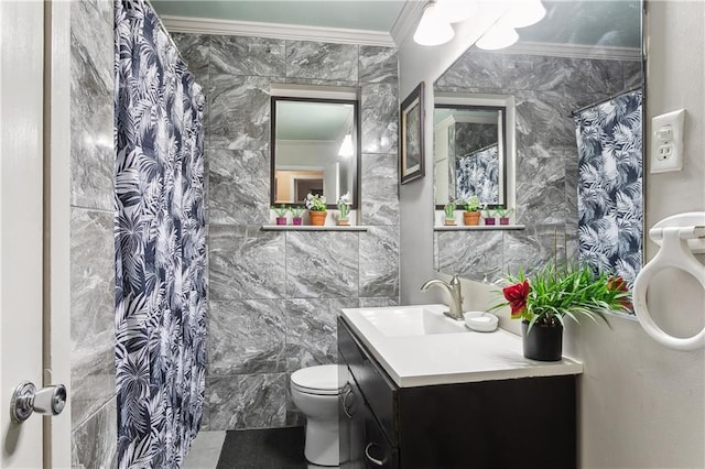 bathroom with a shower with curtain, toilet, vanity, tile walls, and ornamental molding