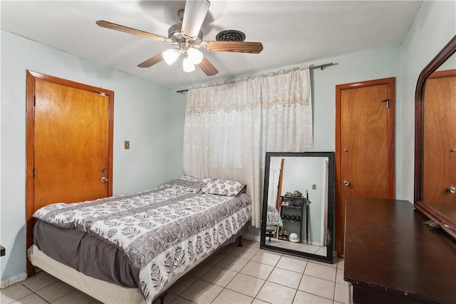 tiled bedroom with ceiling fan