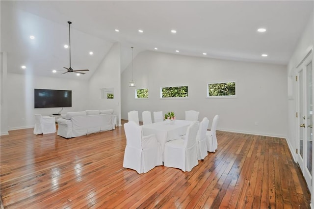 dining area featuring high vaulted ceiling, light hardwood / wood-style flooring, and ceiling fan