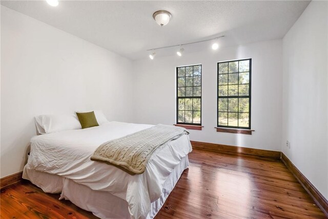 bedroom featuring dark hardwood / wood-style flooring