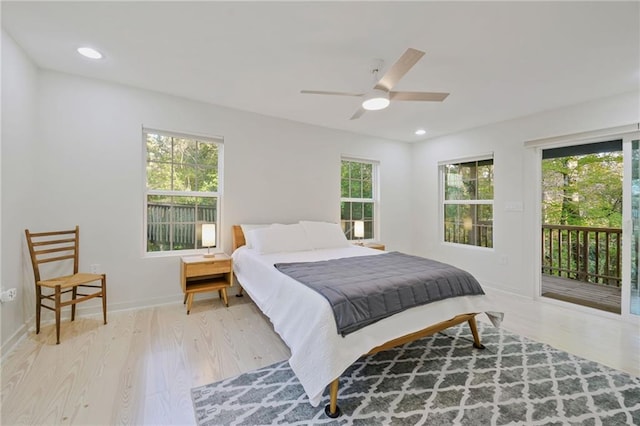 bedroom featuring multiple windows, access to outside, and light hardwood / wood-style flooring