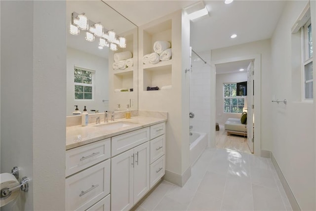 bathroom with vanity, tile patterned flooring, a wealth of natural light, and shower / washtub combination