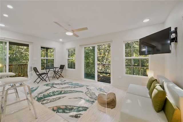 sunroom featuring ceiling fan