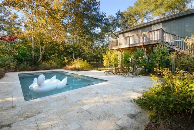 view of swimming pool with a patio area and a deck