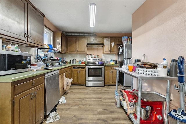 kitchen featuring light hardwood / wood-style flooring, stainless steel appliances, and sink