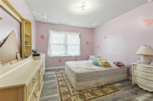 bedroom with hardwood / wood-style floors