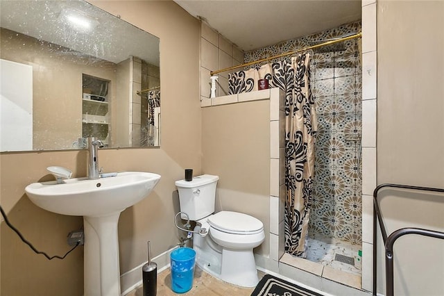 bathroom with tile patterned floors, curtained shower, and toilet