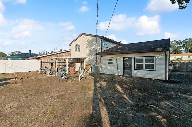 rear view of house with central AC unit