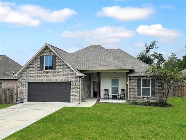 view of front of home with a porch, a front yard, and a garage