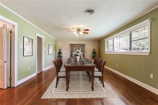 dining room featuring ceiling fan, dark hardwood / wood-style flooring, and ornamental molding