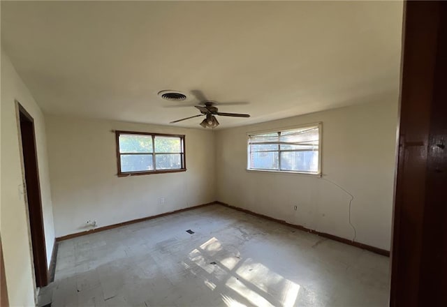 unfurnished bedroom with multiple windows and ceiling fan