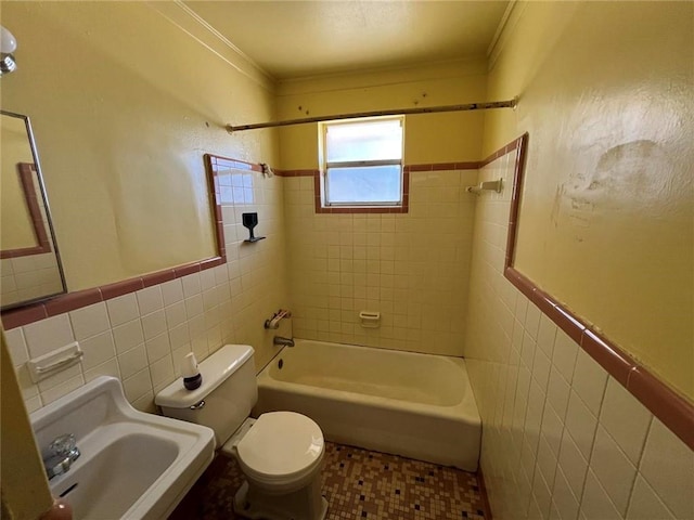 full bathroom with sink, toilet, ornamental molding, and tile walls