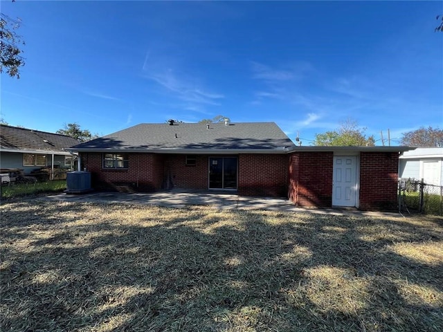 rear view of house featuring central AC