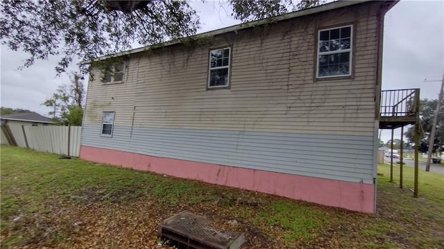 view of side of home with a lawn