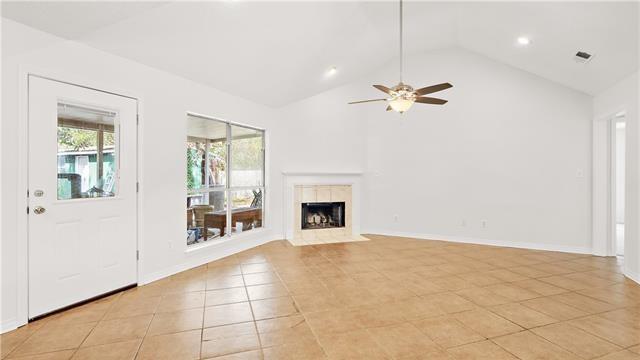 70081 9th St, Covington, LA 70433 - unfurnished living room featuring light tile patterned floors, high vaulted ceiling, ceiling fan, a fireplace, and recessed lighting