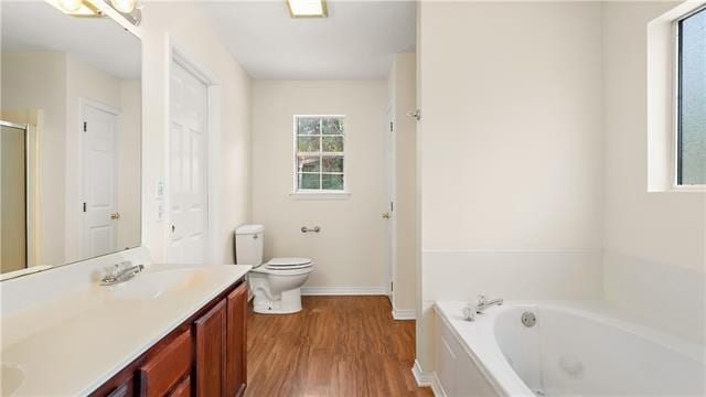 70081 9th St, Covington, LA 70433 - full bath featuring a garden tub, double vanity, wood finished floors, toilet, and a shower with shower door