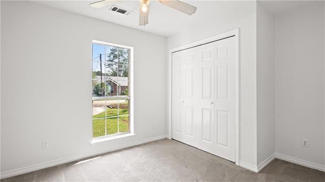 70081 9th St, Covington, LA 70433 - unfurnished bedroom with multiple windows, carpet, a closet, and baseboards