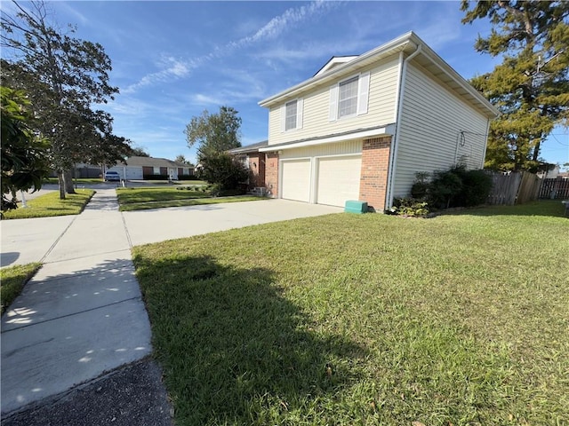 view of side of home featuring a lawn and a garage