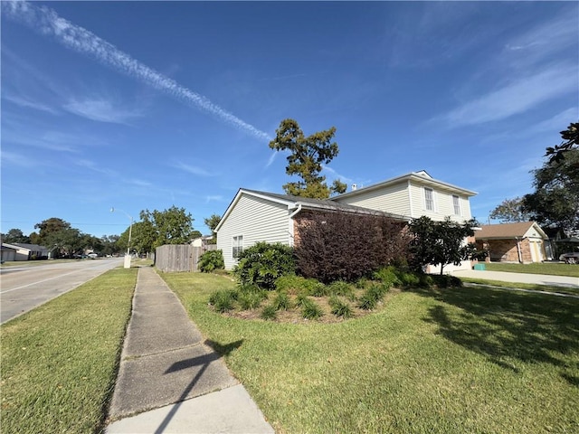 view of side of property featuring a lawn