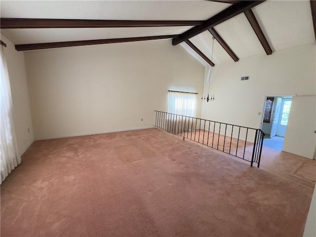 spare room with beam ceiling, light carpet, and high vaulted ceiling