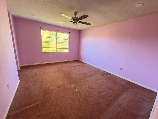 carpeted empty room with ceiling fan and a textured ceiling