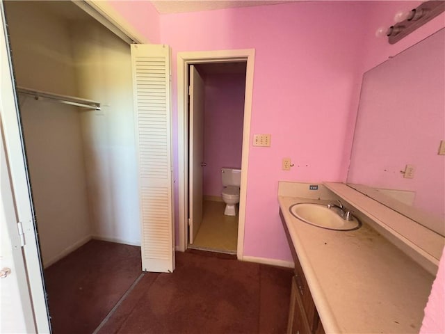 bathroom featuring vanity and toilet