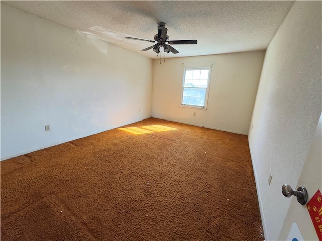 carpeted spare room with a textured ceiling and ceiling fan