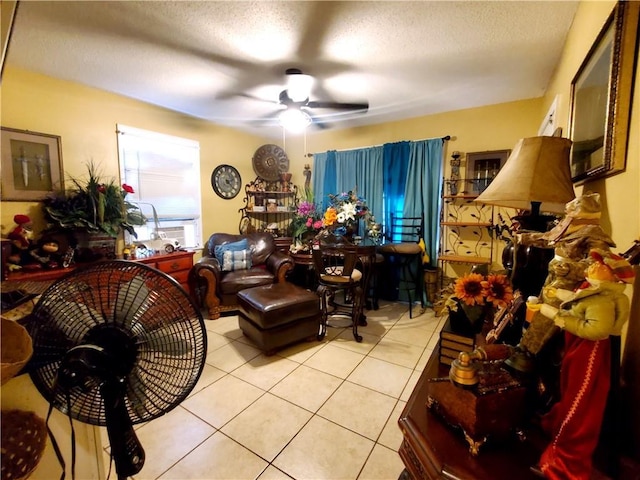 interior space featuring ceiling fan, light tile patterned floors, and a textured ceiling