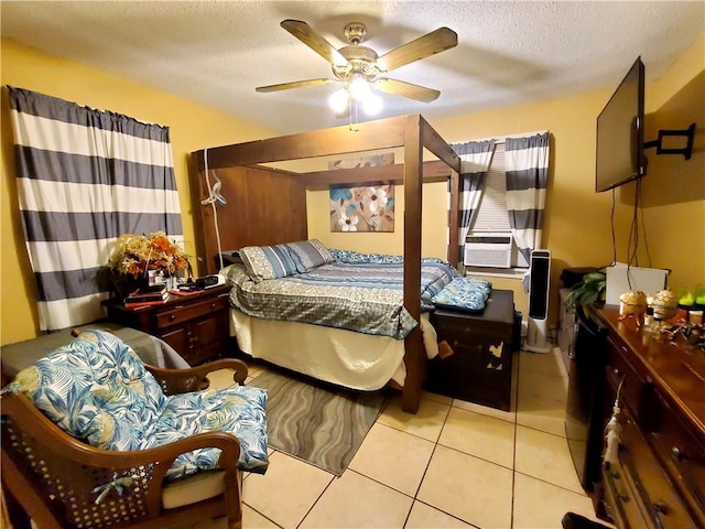 tiled bedroom with ceiling fan, cooling unit, and a textured ceiling