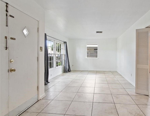 entryway with baseboards, visible vents, and light tile patterned flooring