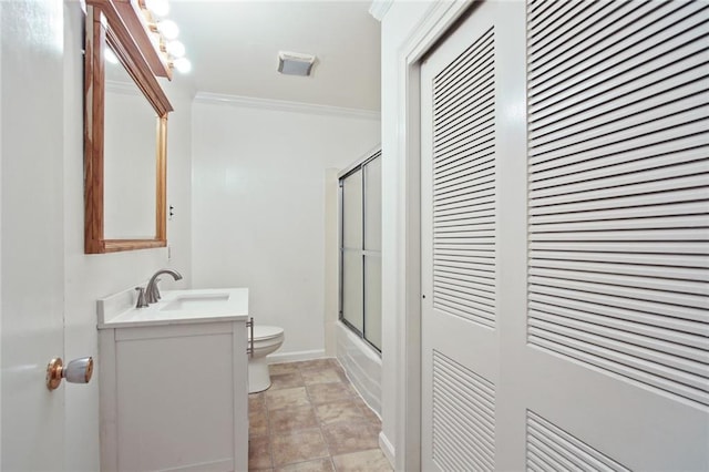 bathroom featuring enclosed tub / shower combo, toilet, vanity, ornamental molding, and a closet