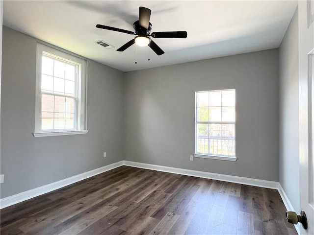 unfurnished room with ceiling fan and dark hardwood / wood-style flooring