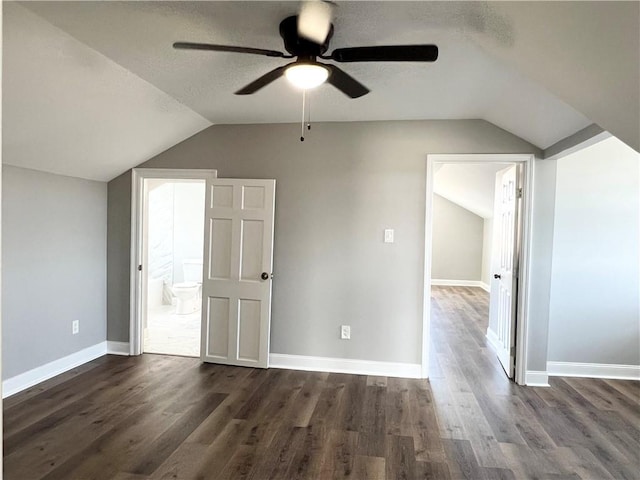 bonus room featuring vaulted ceiling, ceiling fan, and dark wood-type flooring