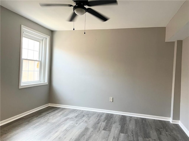 spare room with ceiling fan and wood-type flooring