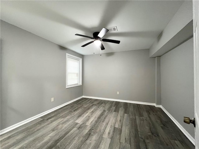 unfurnished room with dark hardwood / wood-style floors and ceiling fan