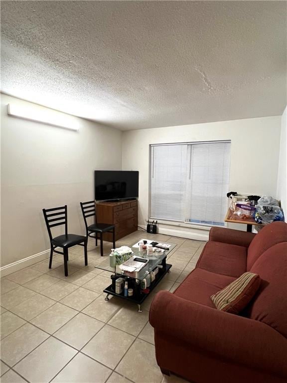 living room with light tile patterned floors and a textured ceiling