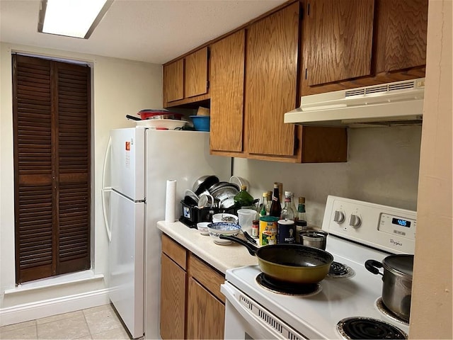 kitchen with light tile patterned floors and white electric range oven