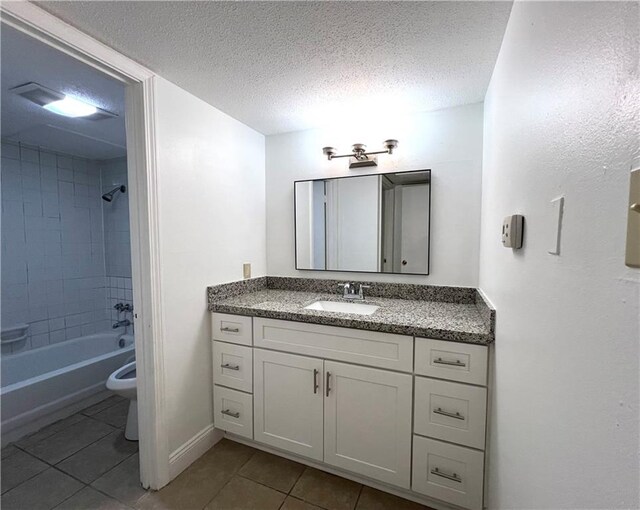 bathroom featuring tile patterned floors, vanity,  shower combination, a textured ceiling, and toilet