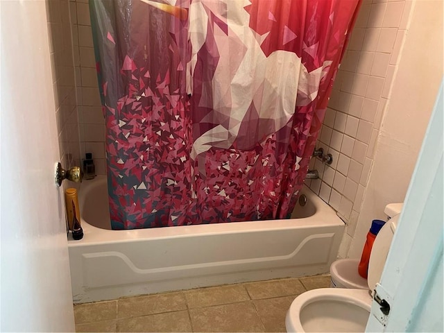 bathroom featuring tile patterned flooring, shower / bath combination with curtain, and toilet