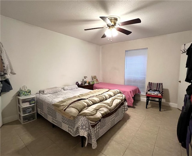 bedroom featuring a textured ceiling and ceiling fan