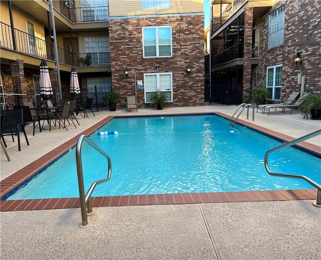 view of swimming pool featuring a patio area